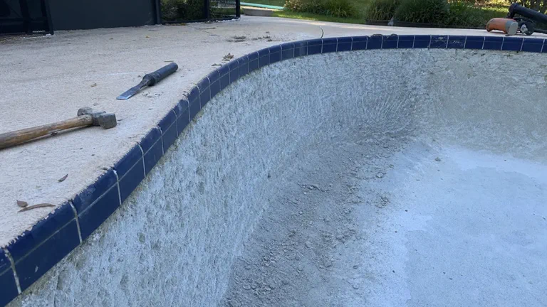 Close view of worn Orlando pool plaster before resurfacing prep
